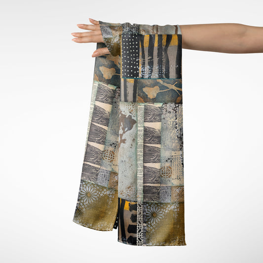 Scarf with patchwork pattern held by a person on a white background