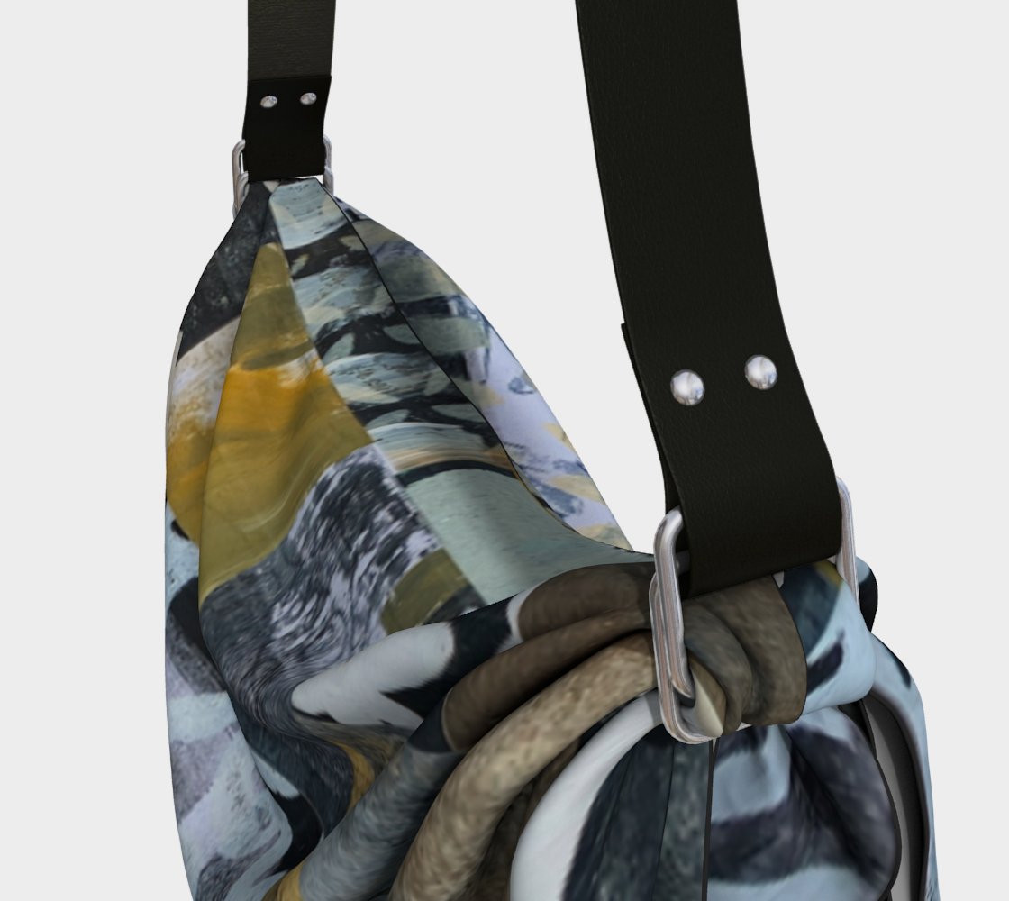 Multicolored patterned bag with a black strap on a light gray background