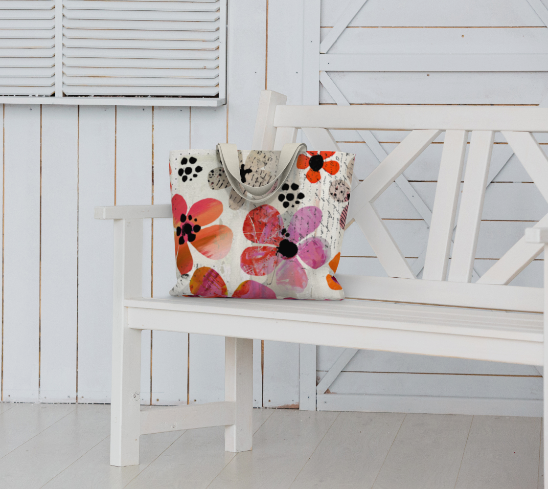 Colorful floral-patterned tote bag on a white bench with a white wooden background