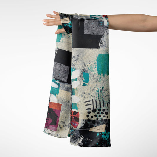 Abstract patterned scarf draped over a person's arm on a white background
