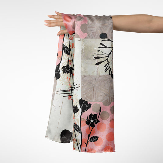 Scarf with floral and abstract patterns held by a person on a white background