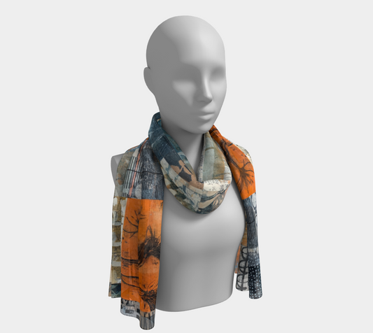 A long scarf with a geometric and nature-inspired pattern displayed on a mannequin.
