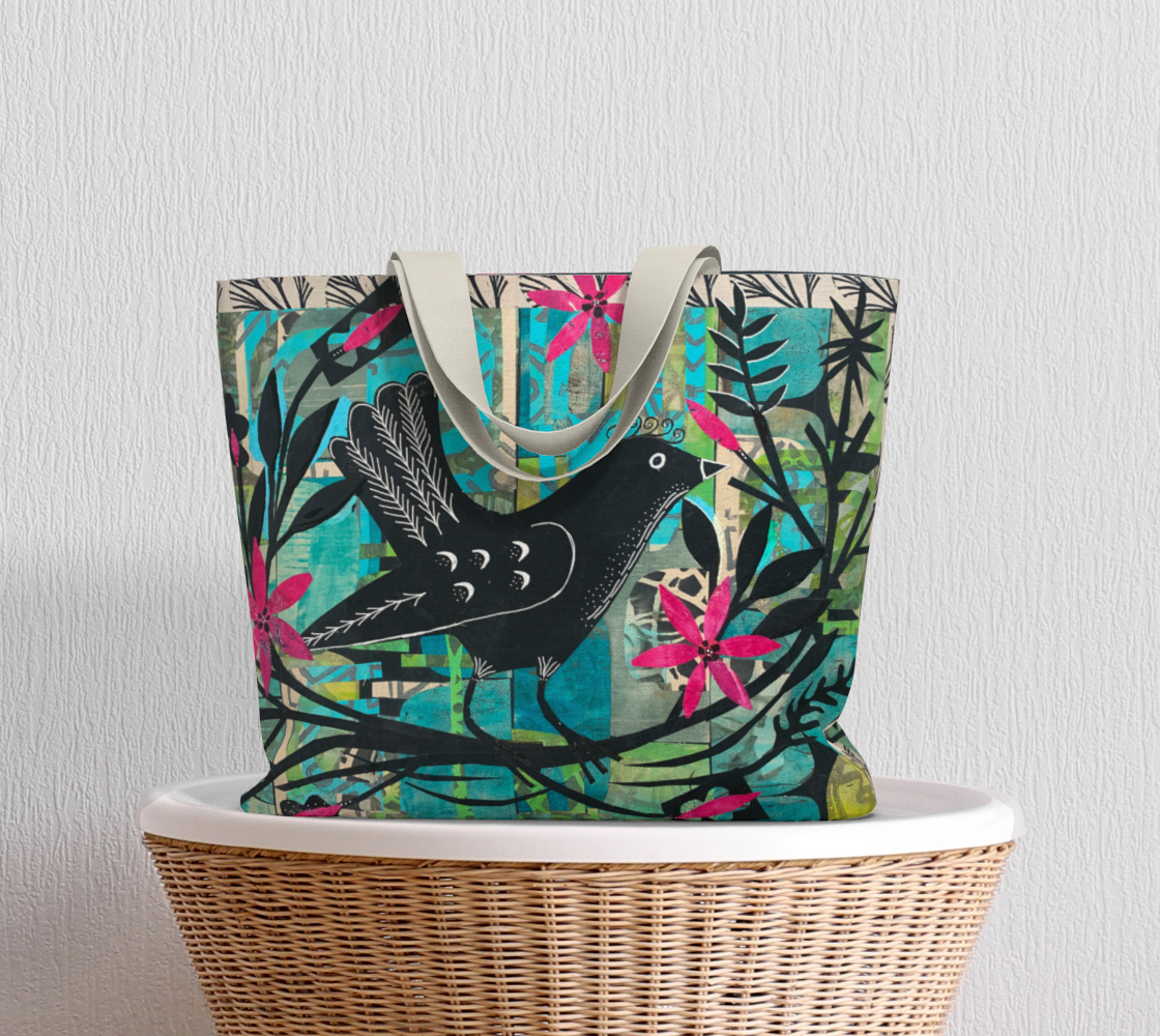 Colorful tote bag with bird design on a wicker chair against a light gray background