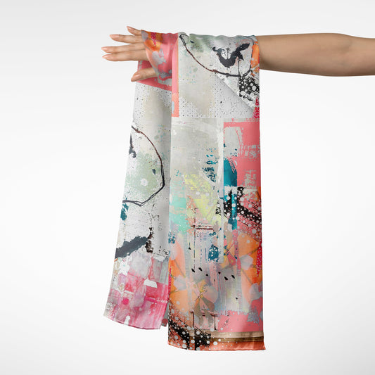 Colorful abstract scarf being held by a person on a white background