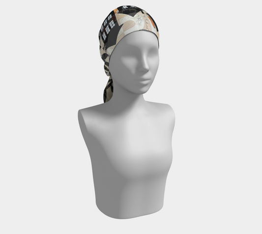 Mannequin head wearing a patterned headscarf on a white background