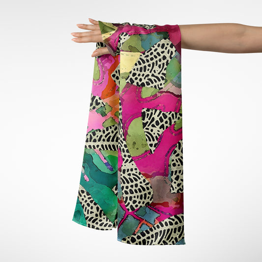 Colorful scarf with abstract pattern held by a person on a white background