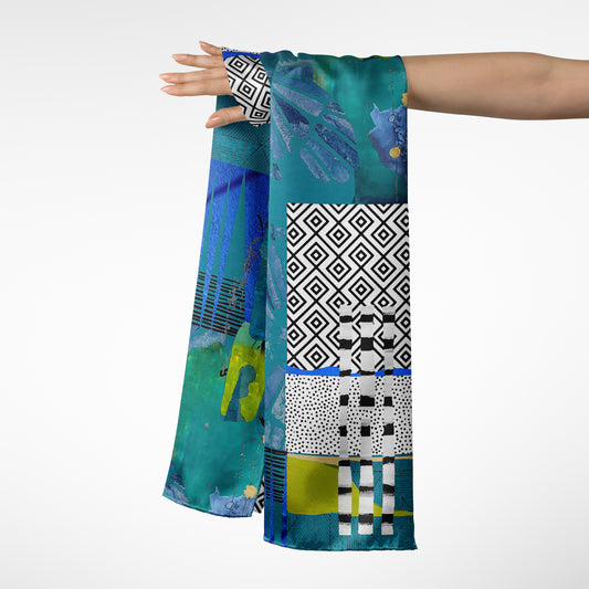 Colorful patterned scarf held by a person on a white background