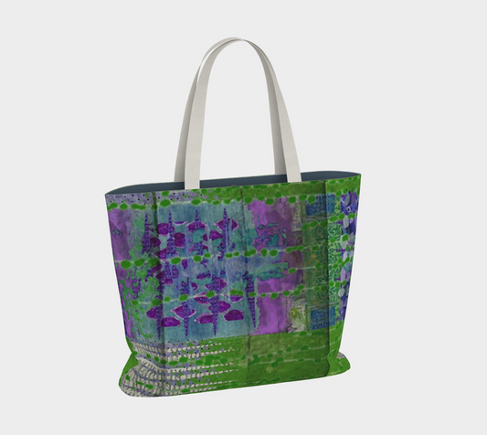 A large multicolored tote bag with a vibrant floral pattern in shades of green and purple, with a solid blue lining and white straps.