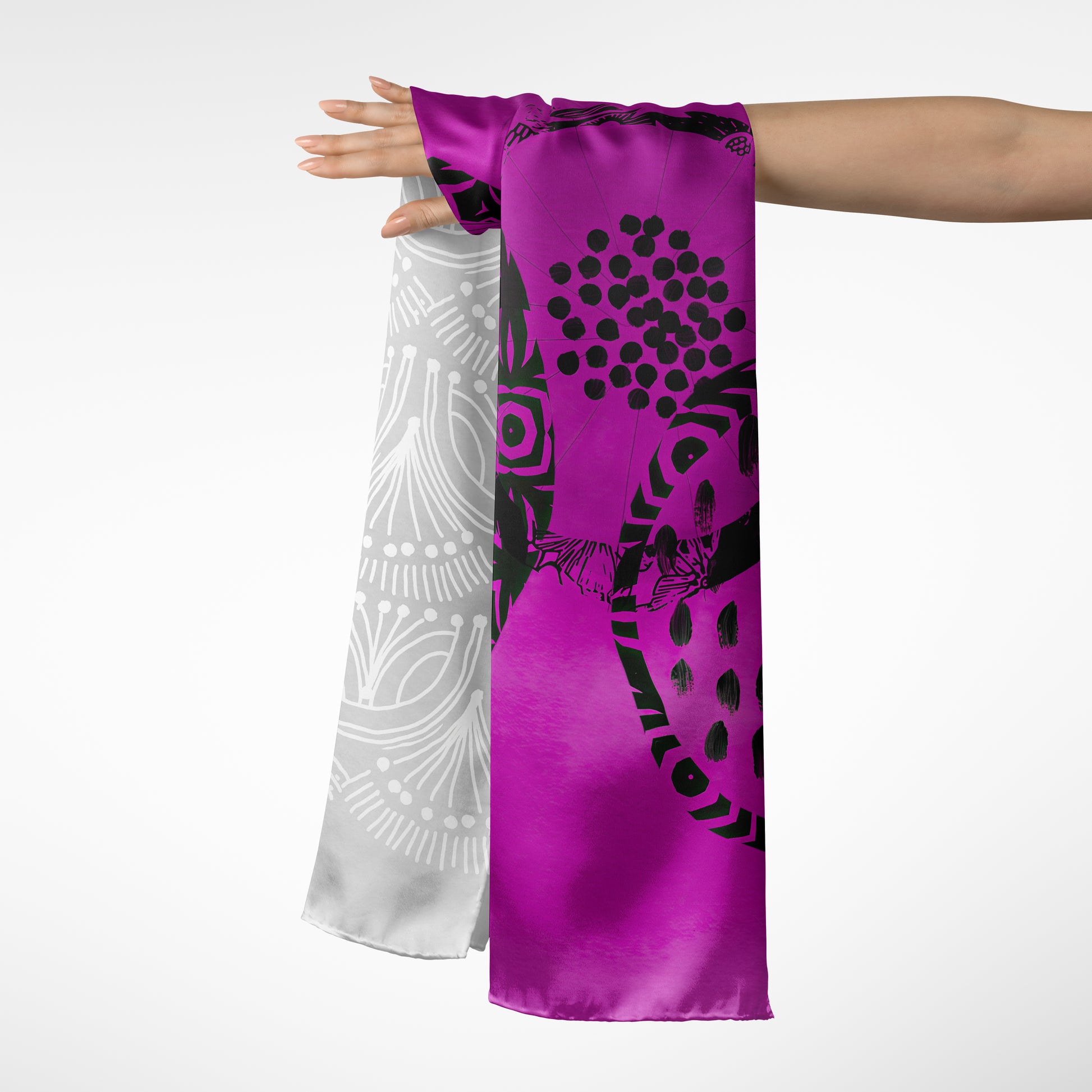 Purple scarf with black and white patterns draped over a person's arm on a white background