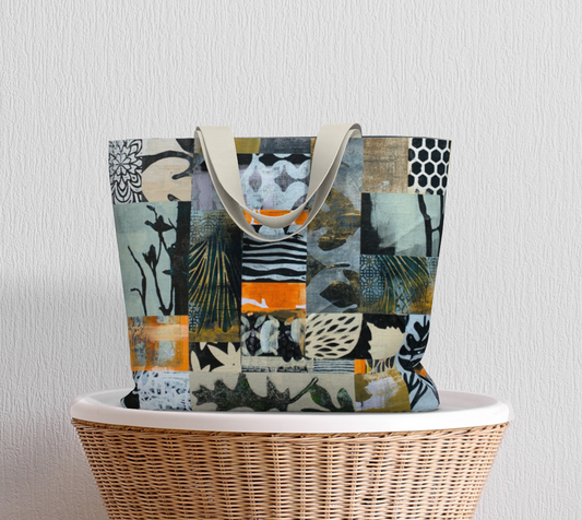 Tote bag with a colorful abstract pattern on a wicker chair against a light gray wall.