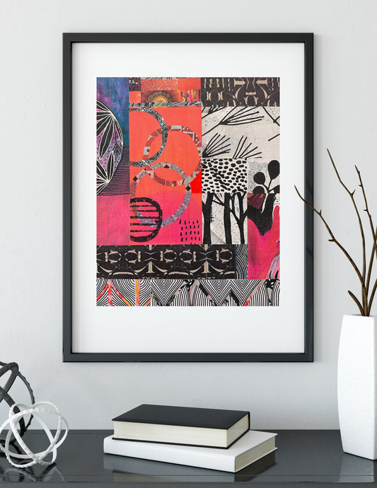 A framed abstract art print with a black frame and white mat, featuring a vibrant collage of pink, orange, black, and white patterns, displayed on a shelf with books and a vase.
