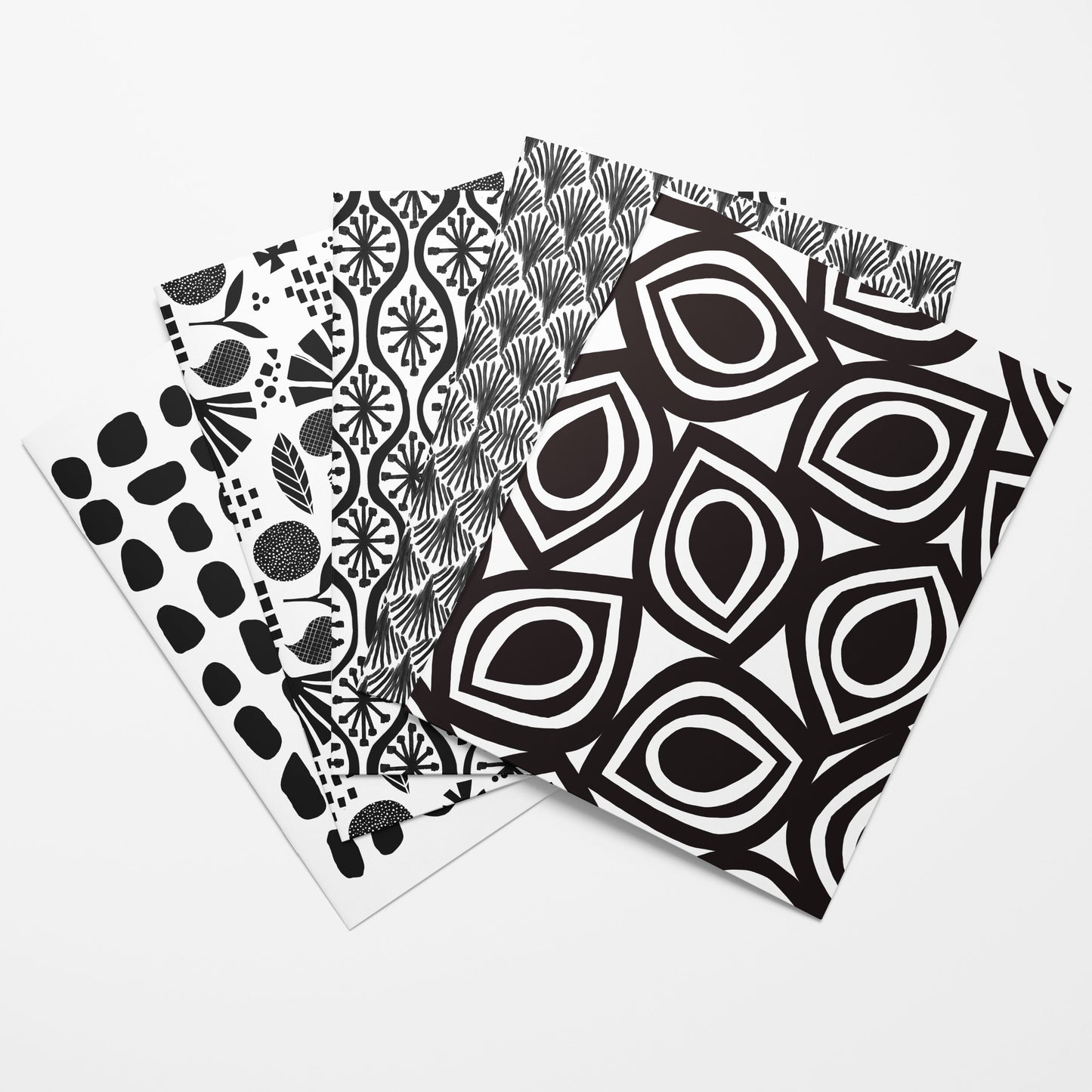 Three black and white patterned cards on a white background