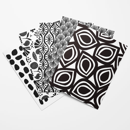 Three black and white patterned cards on a white background