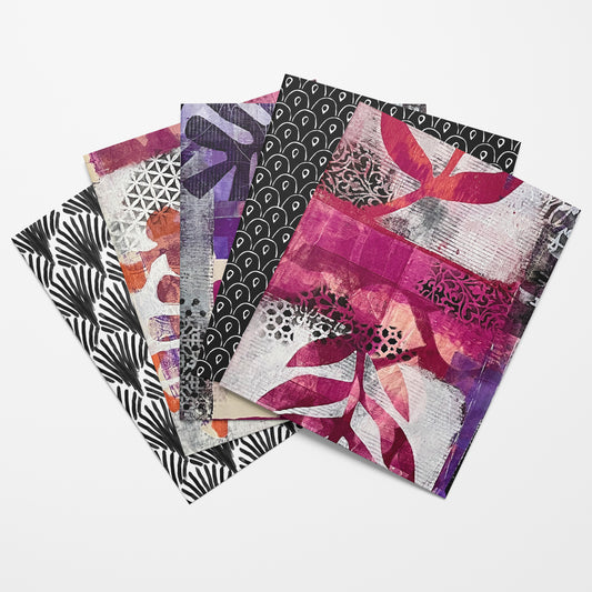 Set of four patterned notebooks on a white background