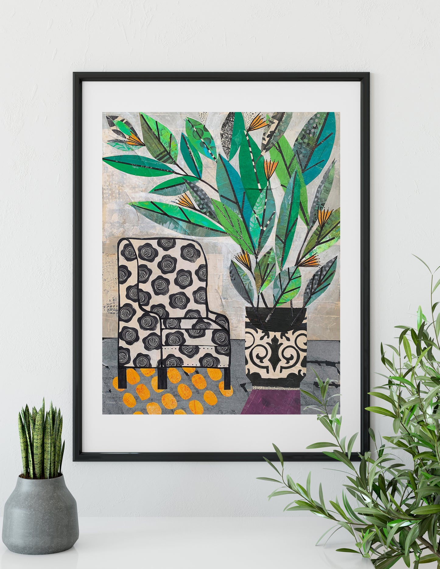 A framed art print featuring a stylized illustration of a patterned armchair and potted plants, displayed on a white wall above a shelf with decorative plants.