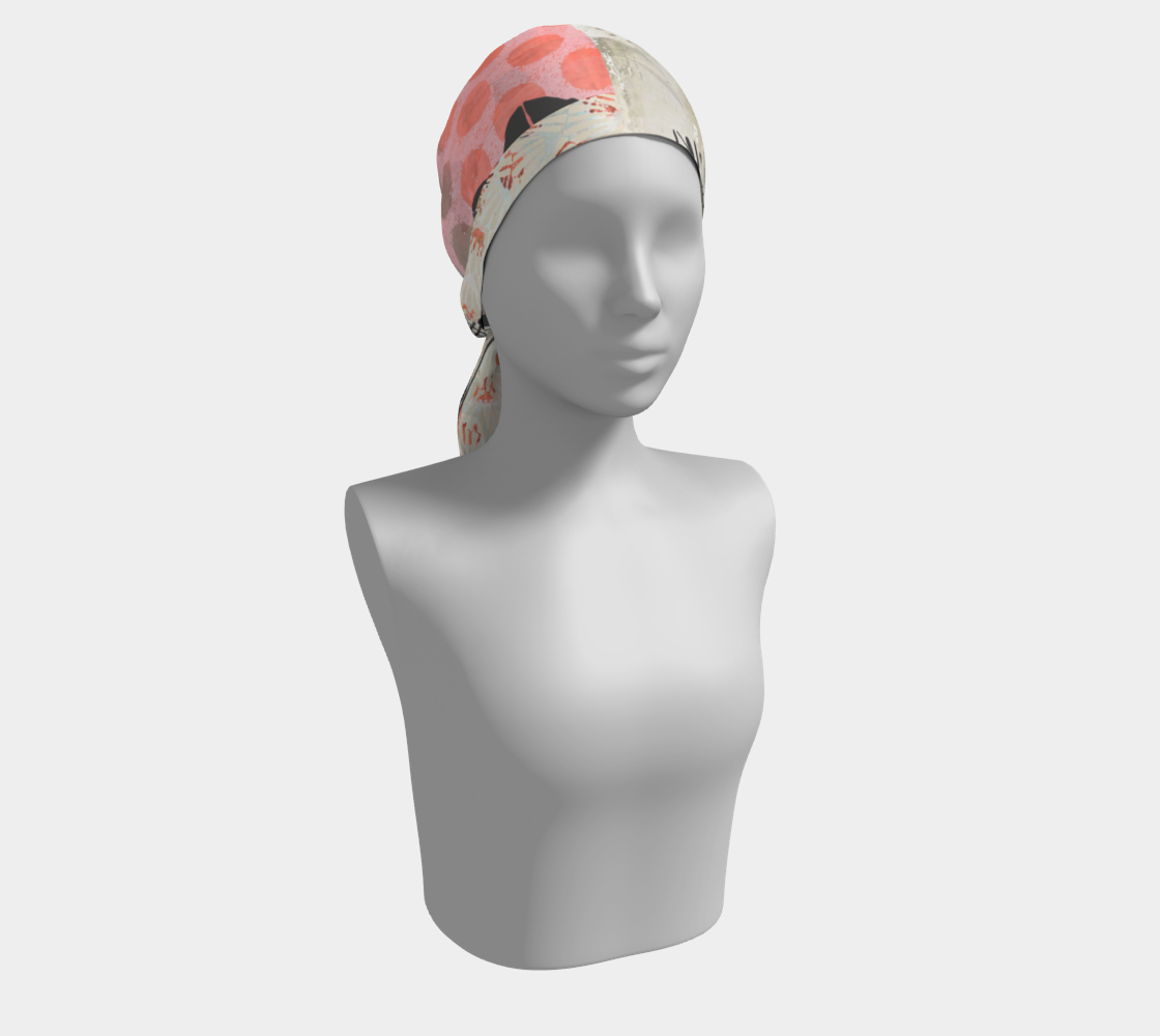 A stylish scarf displayed on a mannequin, featuring a floral design in soft colors like peach, white, and black.