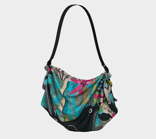 Colorful patterned handbag with a black strap on a light gray background