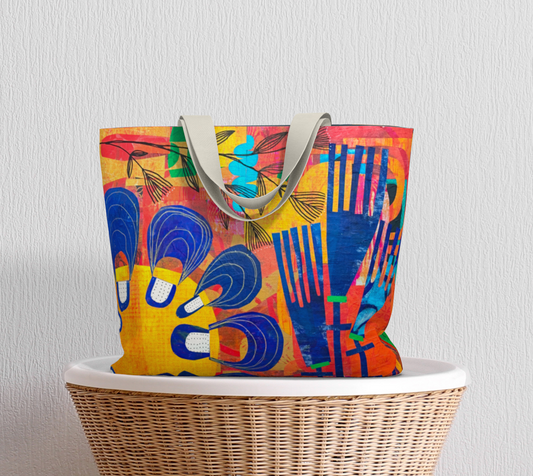 Colorful tote bag with abstract design on a wicker chair against a light gray wall