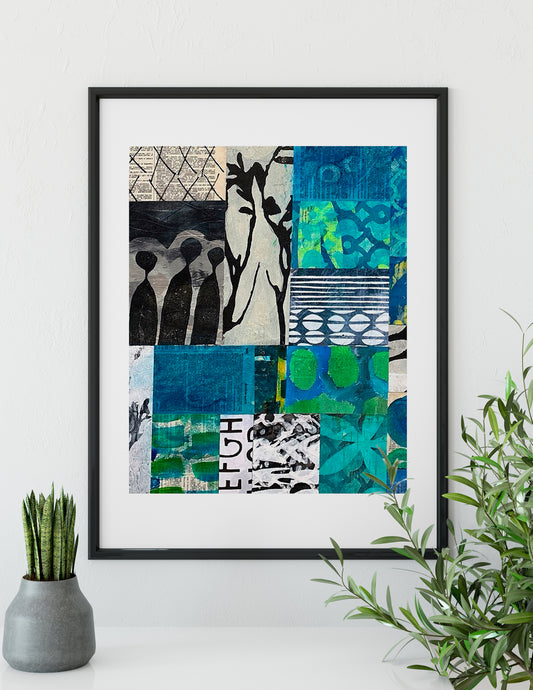 A framed abstract art print featuring a 3x3 grid of blue, green, black, and white patterns, displayed on a white wall above a shelf with a small potted plant and a green leafy branch.