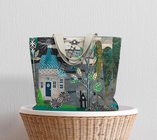 Tote bag with a colorful design of houses and trees on a white surface.