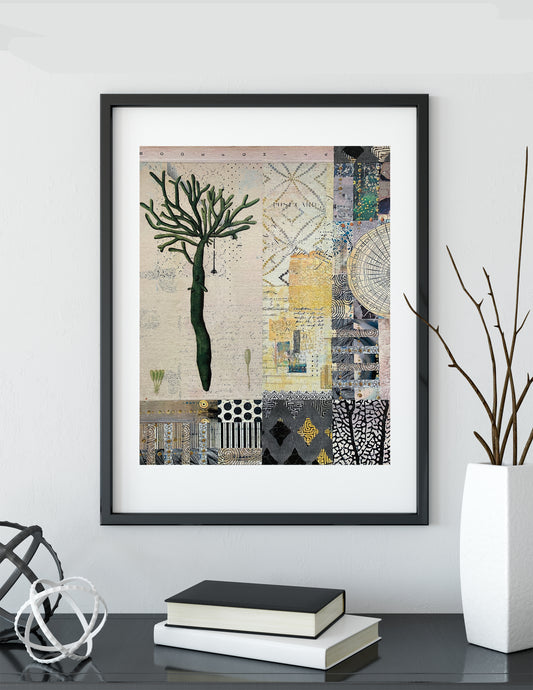 A framed art print featuring a collage of abstract patterns and a stylized tree, displayed on a shelf in a modern room setting with books and a vase.