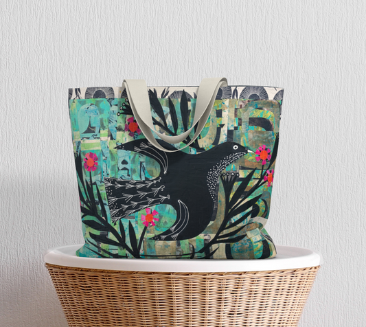 Tote bag with bird design on a wicker chair against a light gray background