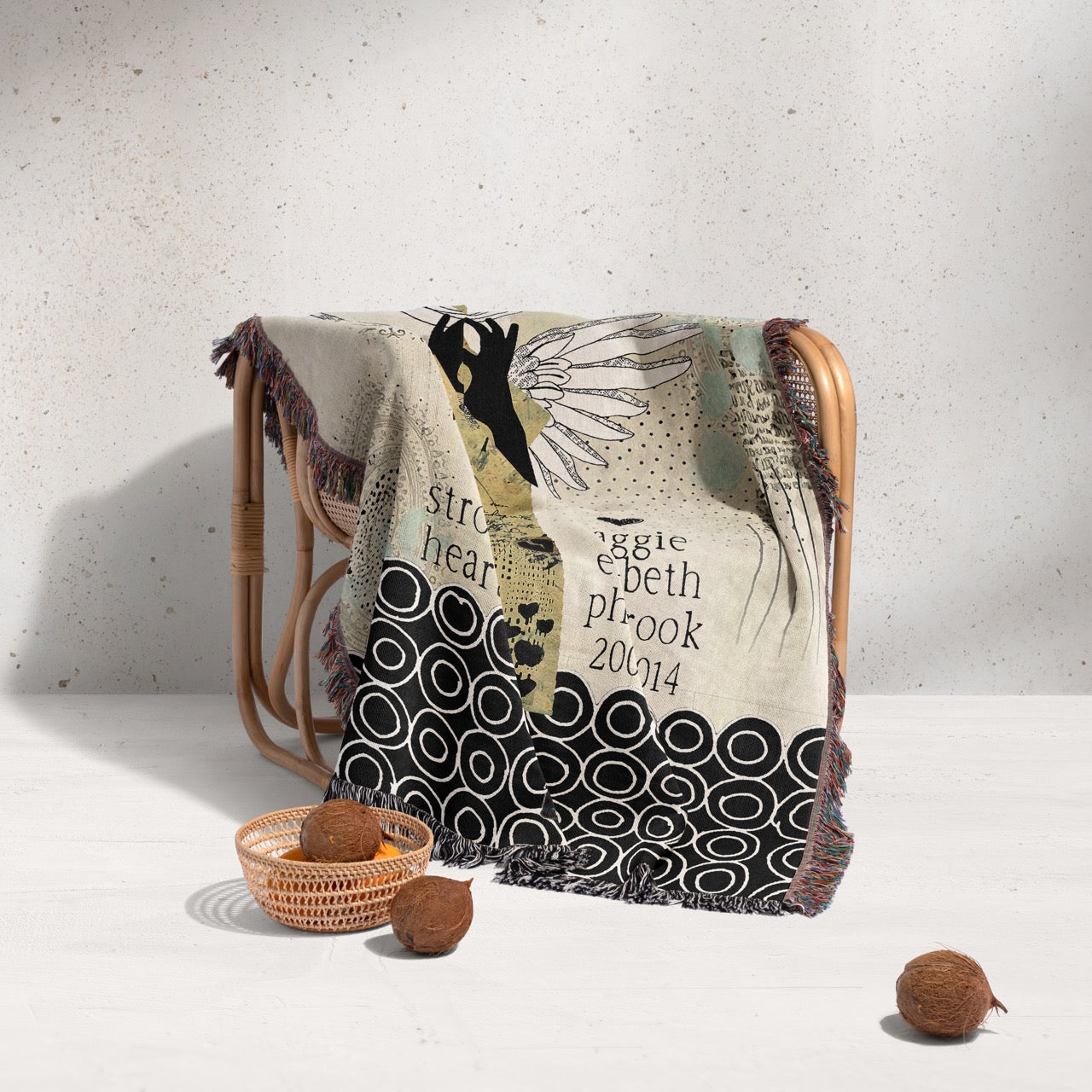 Decorative blanket with artistic design draped over a chair on a light background