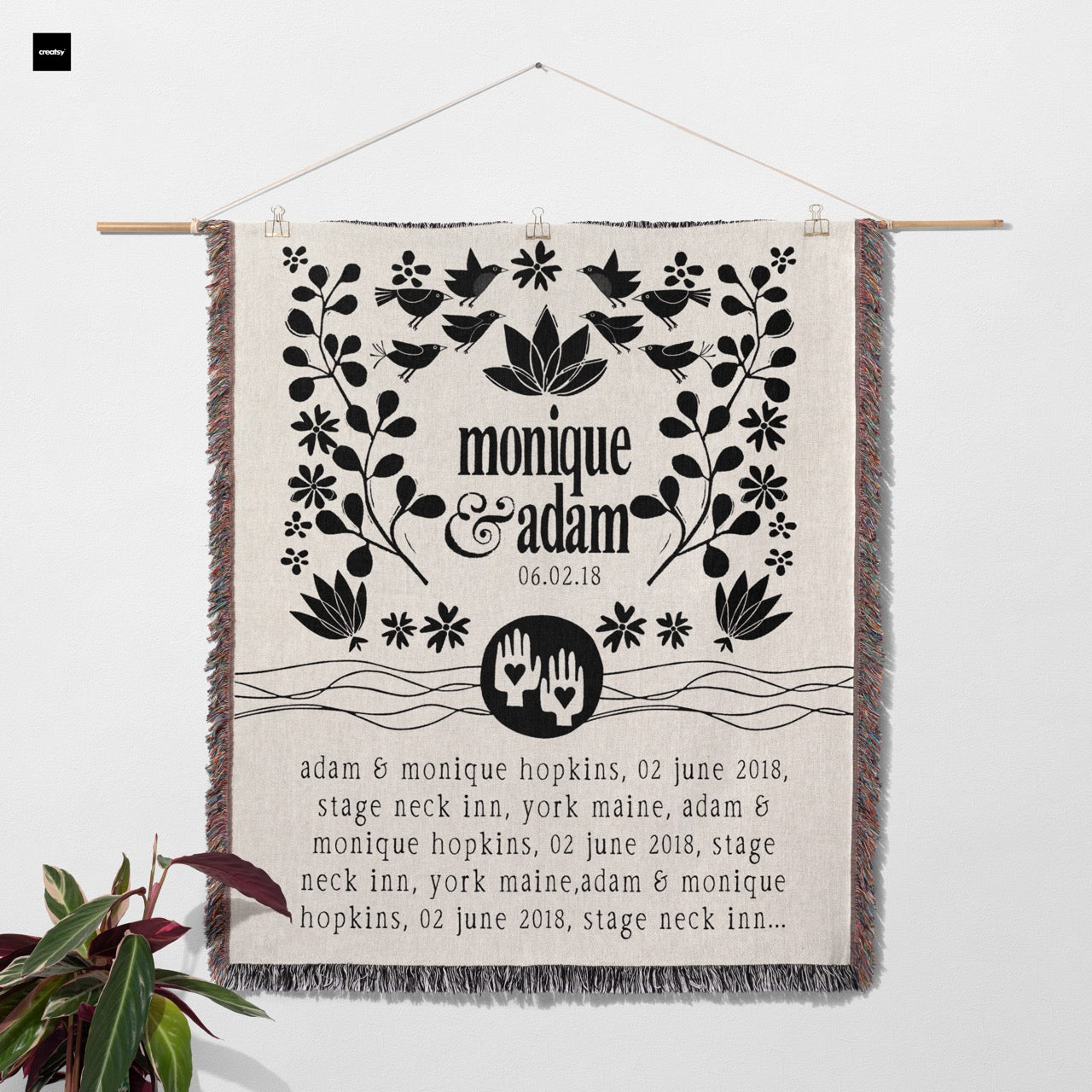 Decorative blanket with text and graphics draped over a chair on a light background
