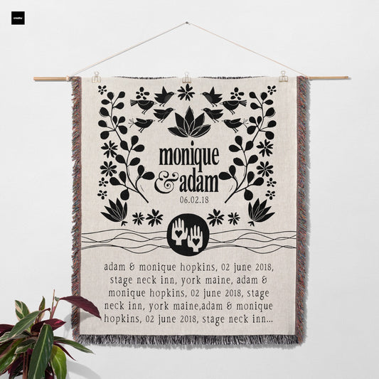 Decorative blanket with text and graphics draped over a chair on a light background