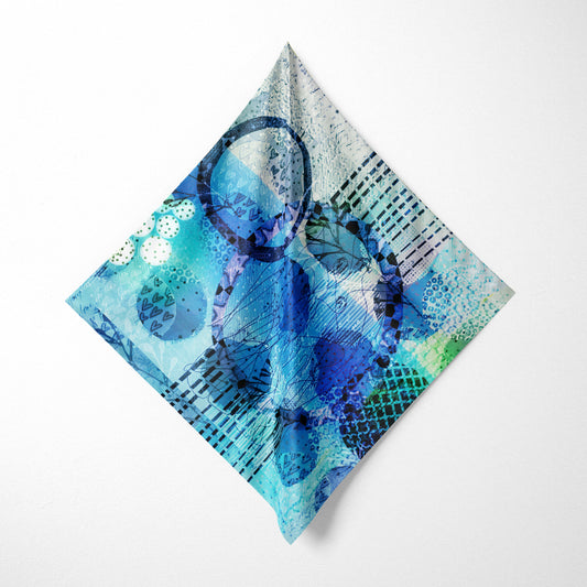 Abstract blue and green patterned fabric on a white background
