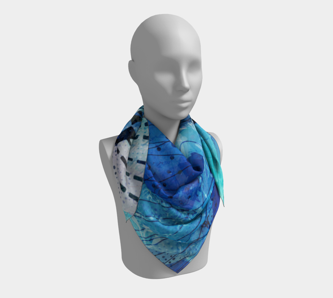 Mannequin wearing a blue and green patterned scarf on a white background
