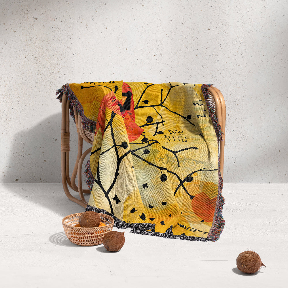 Decorative blanket with artistic design draped over a chair on a light background