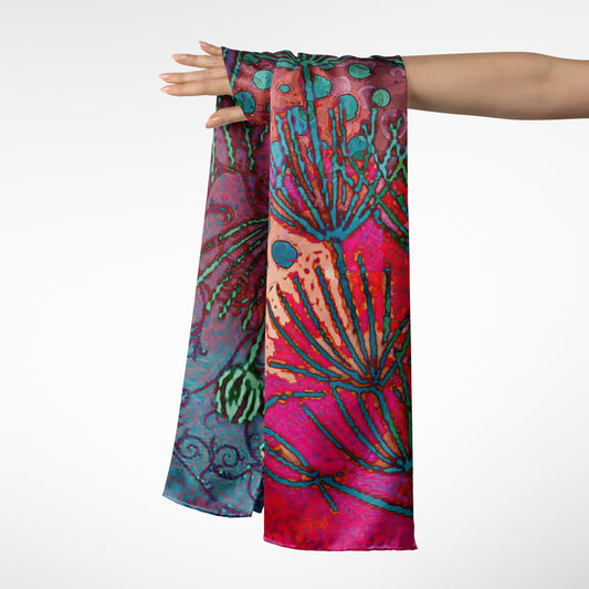 Colorful scarf with abstract design held by a person on a white background