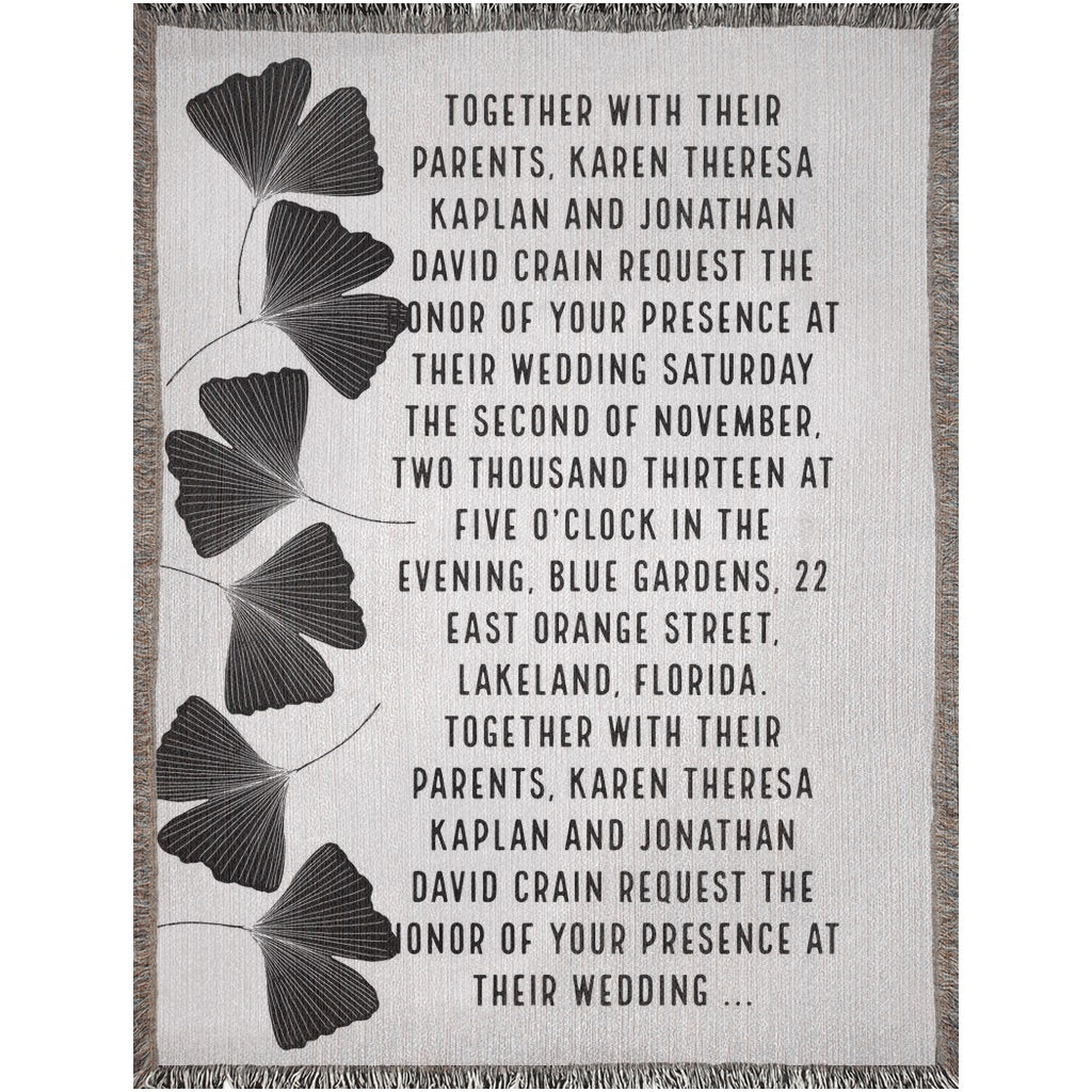 Wedding invitation with ginkgo leaf design on a textured background