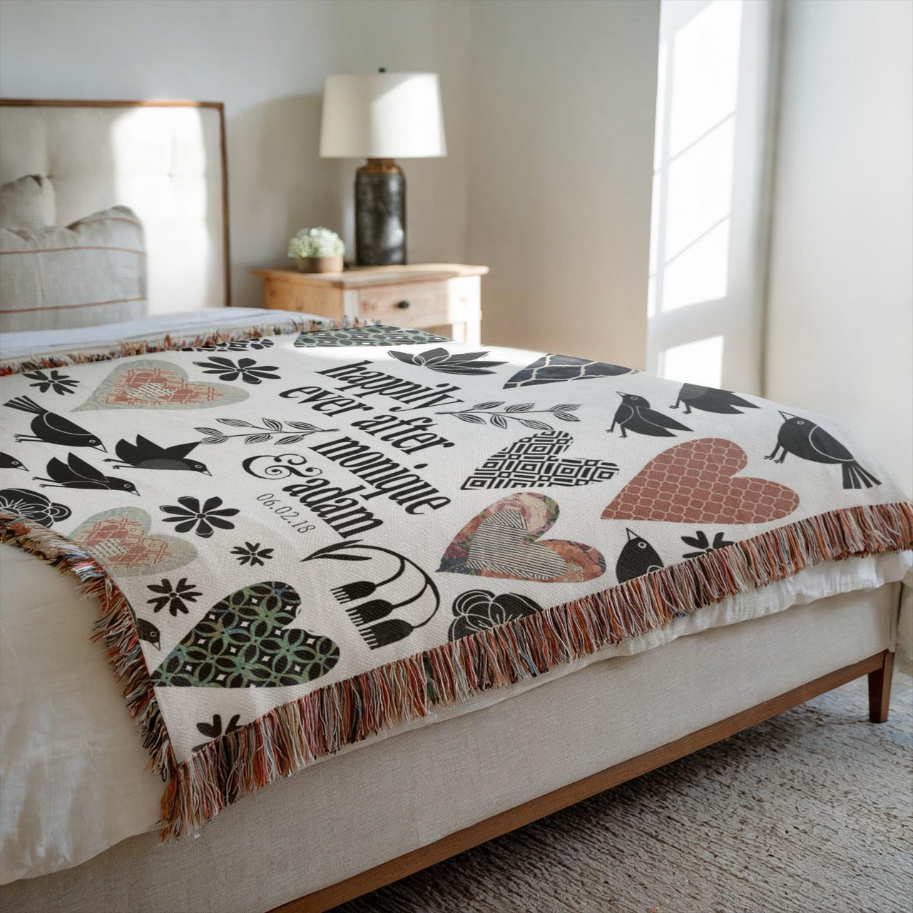 Decorative blanket with heart and bird patterns on a bed in a bedroom.
