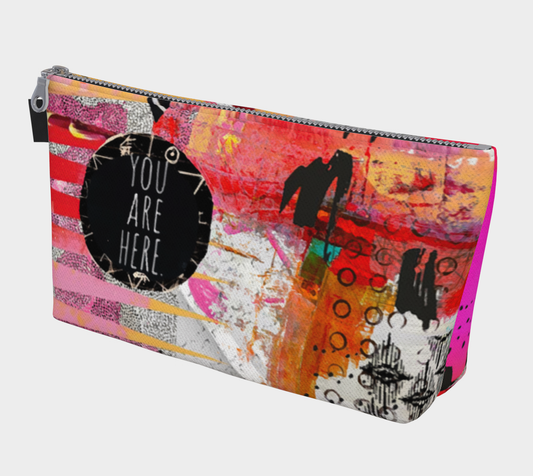 Colorful pouch with abstract design and 'You Are Here' text on a white background