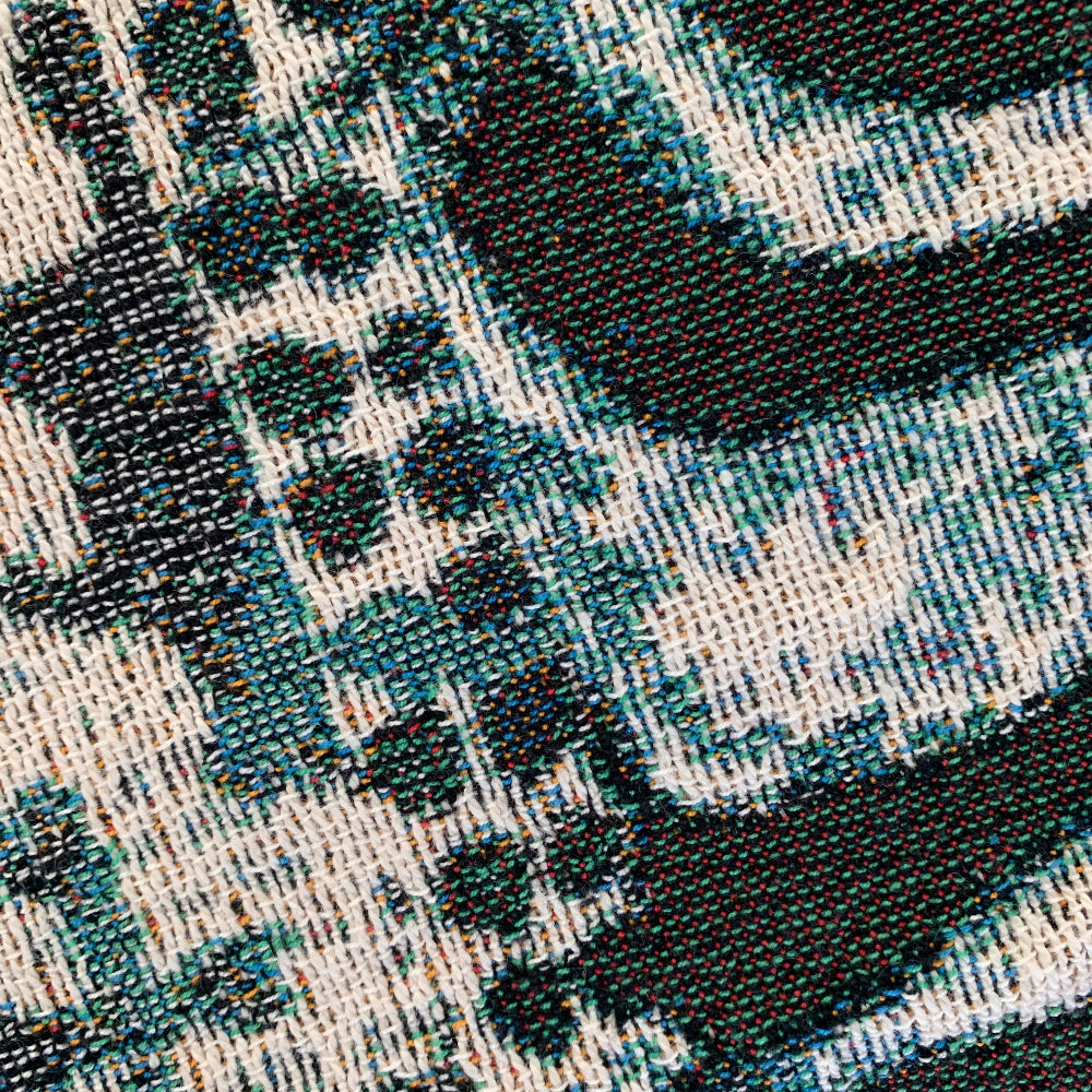 Close-up of a textured fabric with a geometric pattern in black, white, and blue.