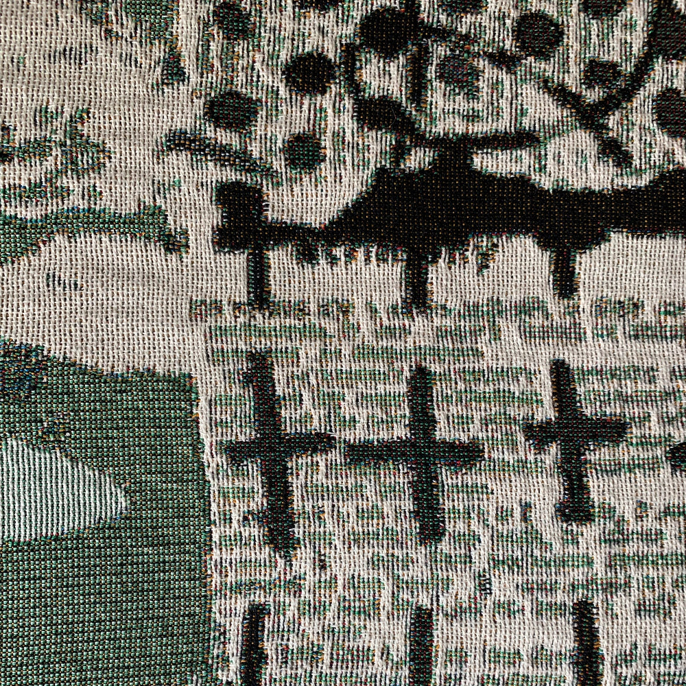 Close-up of a patterned fabric with black crosses on a textured background
