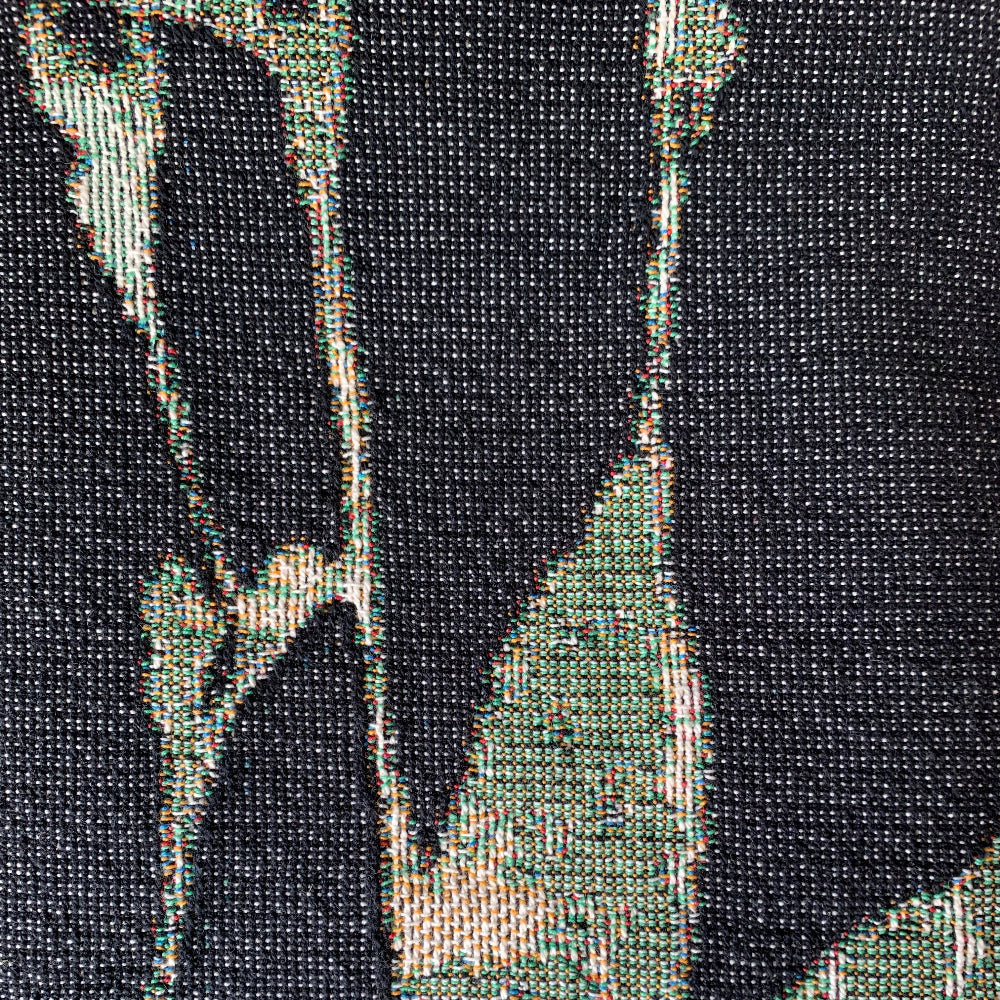 Close-up of a textured black fabric with green accents
