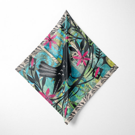 Folded fabric with a colorful floral and bird pattern on a white background
