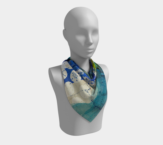 Mannequin wearing a colorful scarf with a map design on a white background