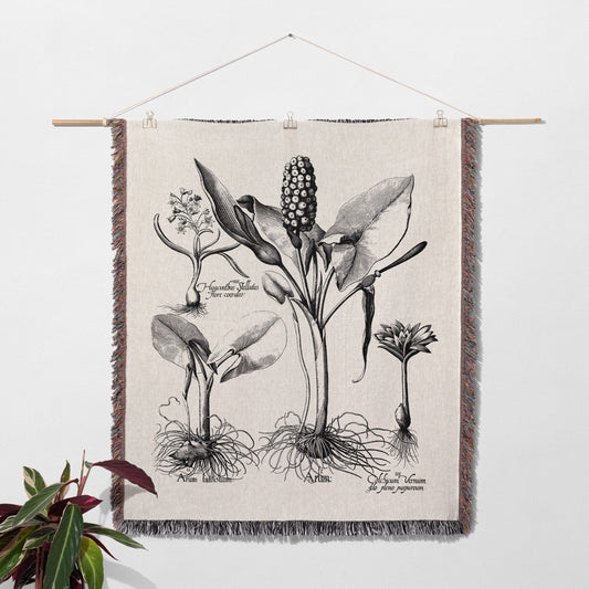 Botanical illustration on a woven tapestry hanging on a wall.