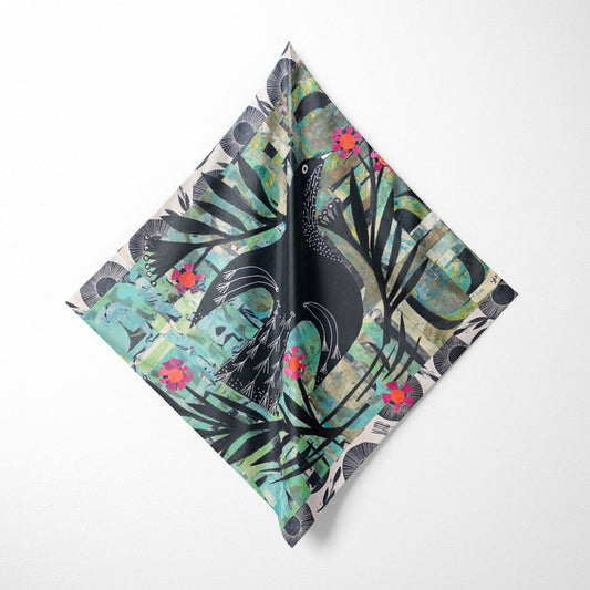 Decorative napkin with a black bird and floral design on a white background