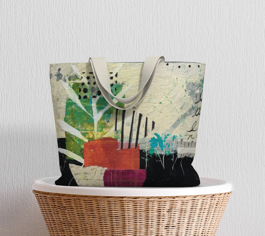 A large tote bag with multicolored abstract art design and white straps.